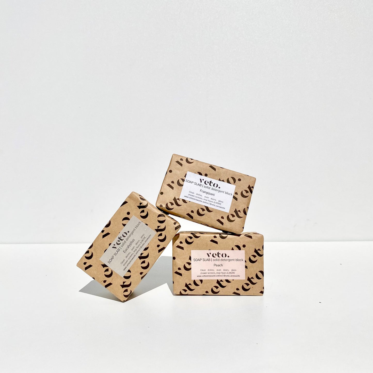 Stack of three veto soap slabs - frangipani, peach and eucalyptus- on a white background